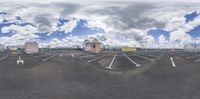 a 360 - ray view of a parking lot with multiple buildings and street lights on it