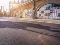 an empty street has been blocked with graffiti on it and the light shines brightly