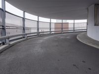 there is a long metal railing next to an open walkway on top of a building