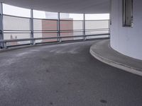 there is a long metal railing next to an open walkway on top of a building