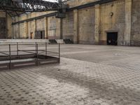 an outdoor area with concrete blocks and rusting on the ground and large steel poles