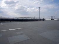 a boat is parked in an empty parking lot near an air port on the water