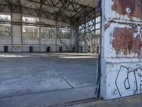 some rusty steel doors that have been painted white and brown with graffiti on them in an old warehouse