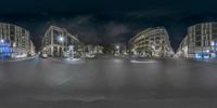 an image of some very wide street at night time with people walking around it in the middle of this shot