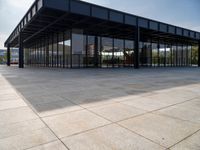 the empty building is very large and the tiled floor looks good looking like it's from a movie