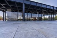 there is a large, empty outdoor covered building that features glass doors and a roof