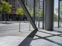 view of an empty city street and the reflection of a building across it in a mirror