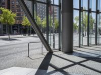 view of an empty city street and the reflection of a building across it in a mirror