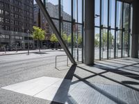 view of an empty city street and the reflection of a building across it in a mirror