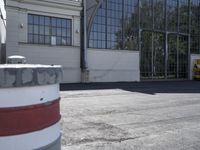 a yellow and white fire hydrant sitting in front of a tall building under a blue sky