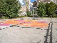 a painted street with a butterfly in the middle of it with graffiti on the pavement