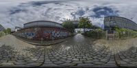 a fisheye view of an outside area of a building with graffiti painted on it