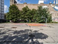 there is an empty lot in the middle of the city with many other old buildings in it