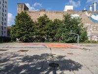 there is an empty lot in the middle of the city with many other old buildings in it