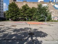 there is an empty lot in the middle of the city with many other old buildings in it