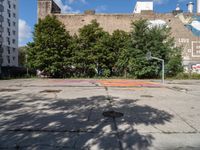 there is an empty lot in the middle of the city with many other old buildings in it