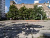 there is an empty lot in the middle of the city with many other old buildings in it