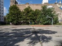 there is an empty lot in the middle of the city with many other old buildings in it