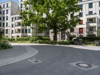 a concrete circle is in the middle of some streets and houses in europe as well