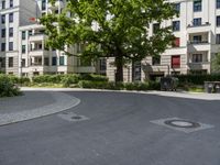 a concrete circle is in the middle of some streets and houses in europe as well