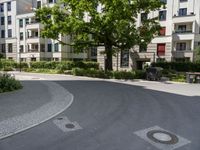 a concrete circle is in the middle of some streets and houses in europe as well