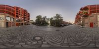 a street view that shows many buildings and a circular street pattern in a panoramic way