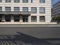 a bus is on the street next to many flags in front of a building on the road