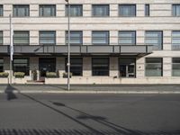 a bus is on the street next to many flags in front of a building on the road