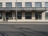 a bus is on the street next to many flags in front of a building on the road