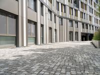 brick road in front of modern urban buildings in europe as seen from the side view