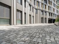 brick road in front of modern urban buildings in europe as seen from the side view