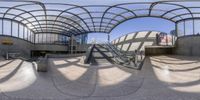 a spherical photo of a building with an escalator and stairs inside of it