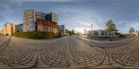 there are many buildings on the street in this big fisheye lens image, it looks like they have a nice view