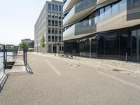 there is an empty street between two large buildings in the city where the building sits