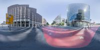 a group of buildings in the city and people crossing the street behind it by a star blanket