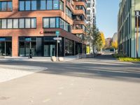 a picture of an empty street in front of a tall building with windows and a sign above it that says u s bank