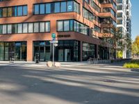 a picture of an empty street in front of a tall building with windows and a sign above it that says u s bank