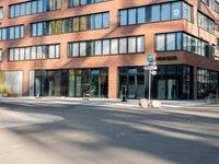 a picture of an empty street in front of a tall building with windows and a sign above it that says u s bank