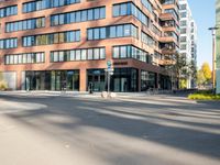 a picture of an empty street in front of a tall building with windows and a sign above it that says u s bank