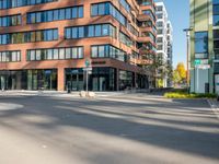 a picture of an empty street in front of a tall building with windows and a sign above it that says u s bank