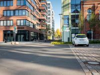 a picture of an empty street in front of a tall building with windows and a sign above it that says u s bank