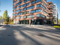 a picture of an empty street in front of a tall building with windows and a sign above it that says u s bank