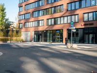 a picture of an empty street in front of a tall building with windows and a sign above it that says u s bank