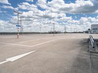 an empty parking lot with a lot of cars parked near it, and there are no clouds in the sky