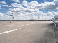 an empty parking lot with a lot of cars parked near it, and there are no clouds in the sky