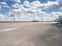 an empty parking lot with a lot of cars parked near it, and there are no clouds in the sky