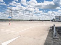 an empty parking lot with a lot of cars parked near it, and there are no clouds in the sky