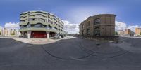 the 360 - degree image shows a curved intersection and two buildings next to each other