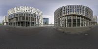 the two circular buildings are in the middle of the street and there is also a circular picture of an office building