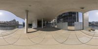 360 - view image of a building near water and trees on the street below it